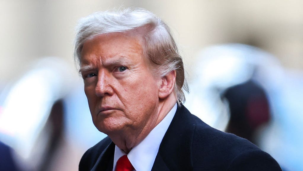 Former US President Donald Trump arrives at 40 Wall Street after his court hearing to determine the date of his trial for allegedly covering up hush money payments linked to extramarital affairs in New York City on March 25, 2024. Trump faces twin legal crises today in New York, where he could see the possible seizure of his storied properties over a massive fine as he separately fights to delay a criminal trial even further. (Photo by Charly TRIBALLEAU /
 AFP) (Photo by CHARLY TRIBALLEAU/AFP via Getty Images)