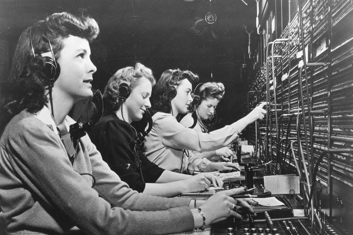 A black and white photo of women working operator lines, likely in the 1940s based on the hair.