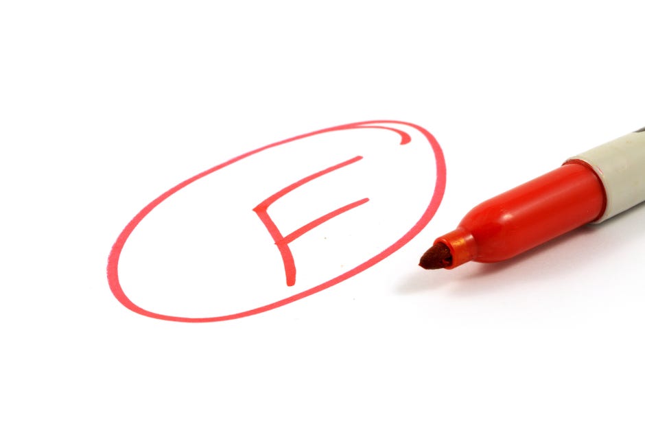 a school paper marked F with a red marker