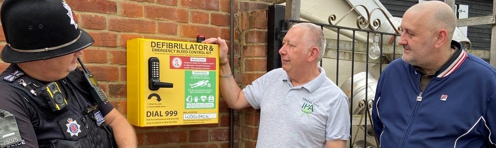 The Woolpack landlord, centre, and customer Glenn Randall show Special Sergeant Simon Jesse the new life-saving equipment