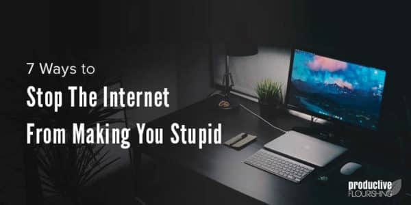 Computer and desk in the dark. Text overlay: 7 Ways to Stop The Internet From Making You Stupid