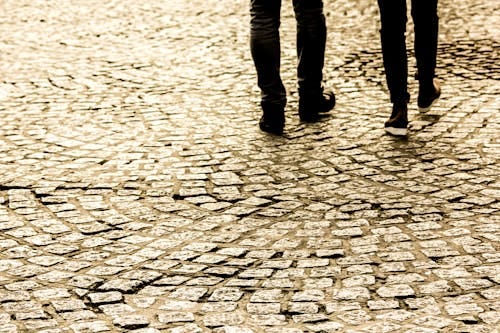 Free Person Waling on Concrete Bricks Road Stock Photo