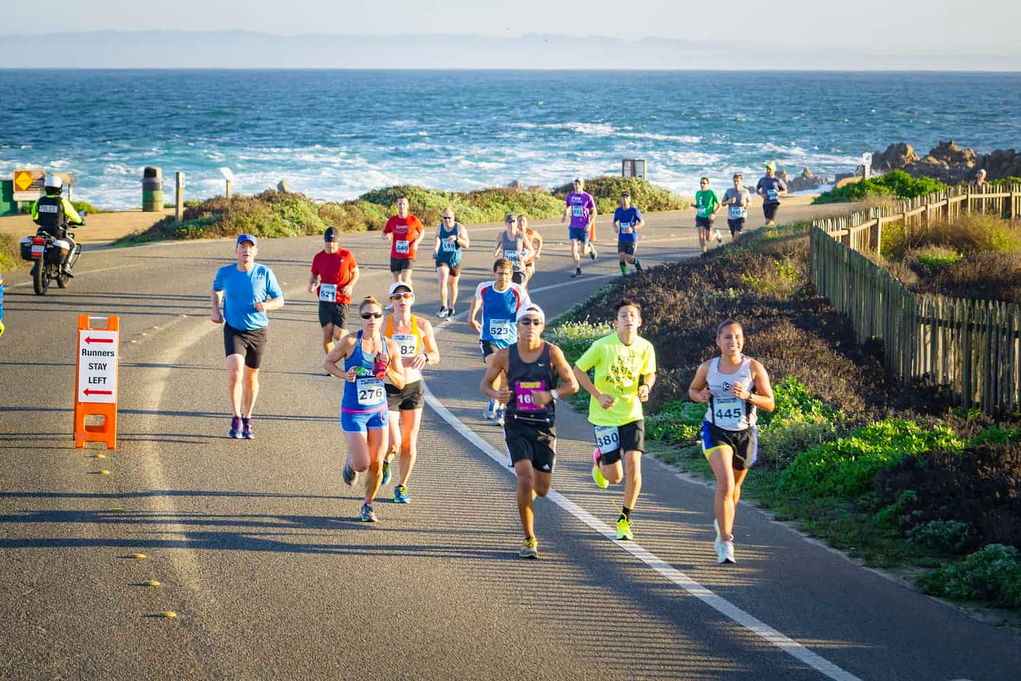 Runners make their way along the edge of the Pacific Ocean at the Monterey Bay Half Marathon in Monterey, Calif.