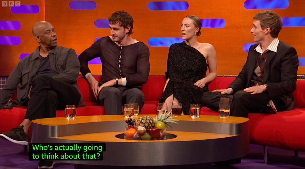 Paul Mescal saying "who's actually going to think about that" as Denzel Washington, Eddie Redmayne, and Saoirse Ronan look on