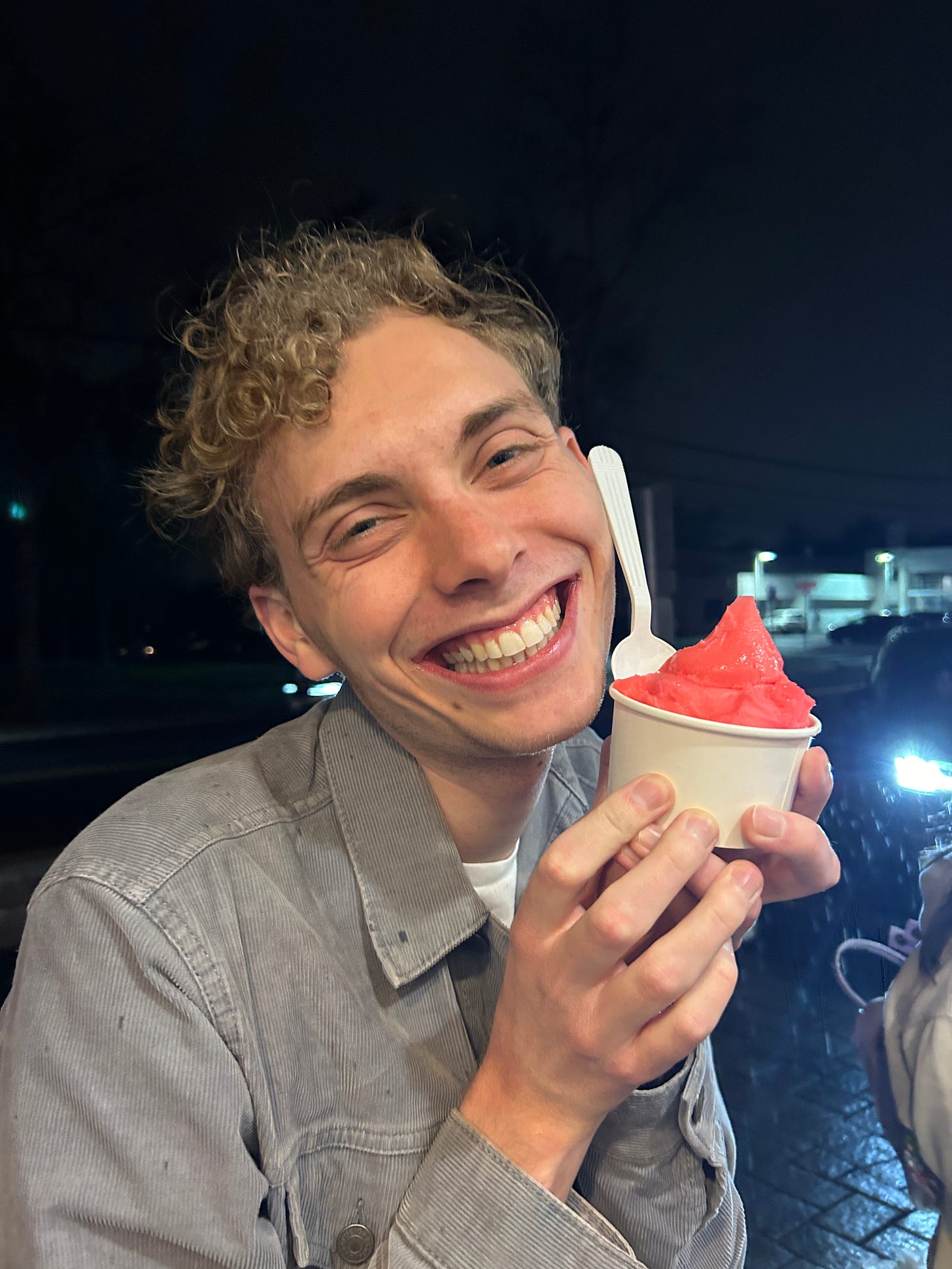 Owen grins while holding a gorgeous cup of pink sherbet.