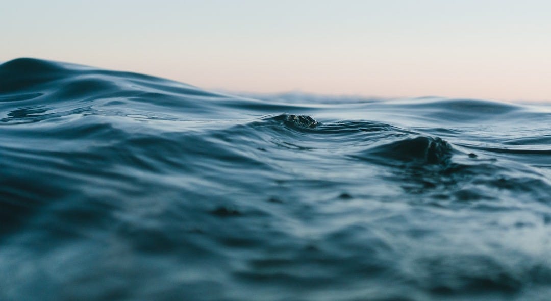 body of water under sky