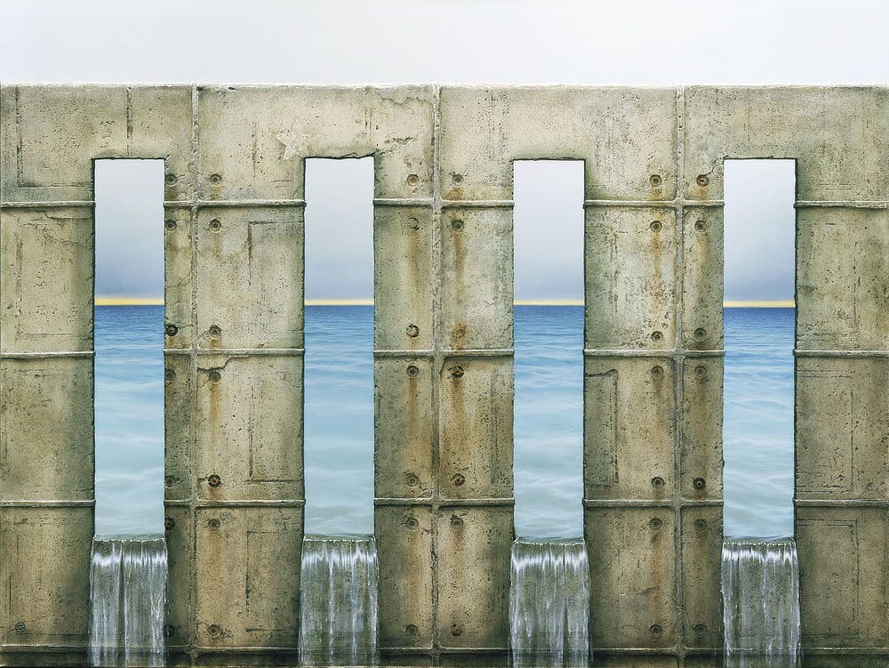 Water pours through four vertical channels cut into the face of a wide stone wall. The concrete is marked with rectangular seams from when it was poured. The white paint of a 5-pointed star fades at the top corner of one inlet. Beyond, the clear blue ocean gives way to dreary gray sky, the two separated by a yellow line sitting on the horizon.