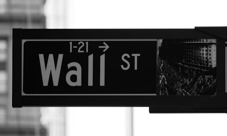grayscale photo of Wall St. signage grayscale photo of Wall St. signage