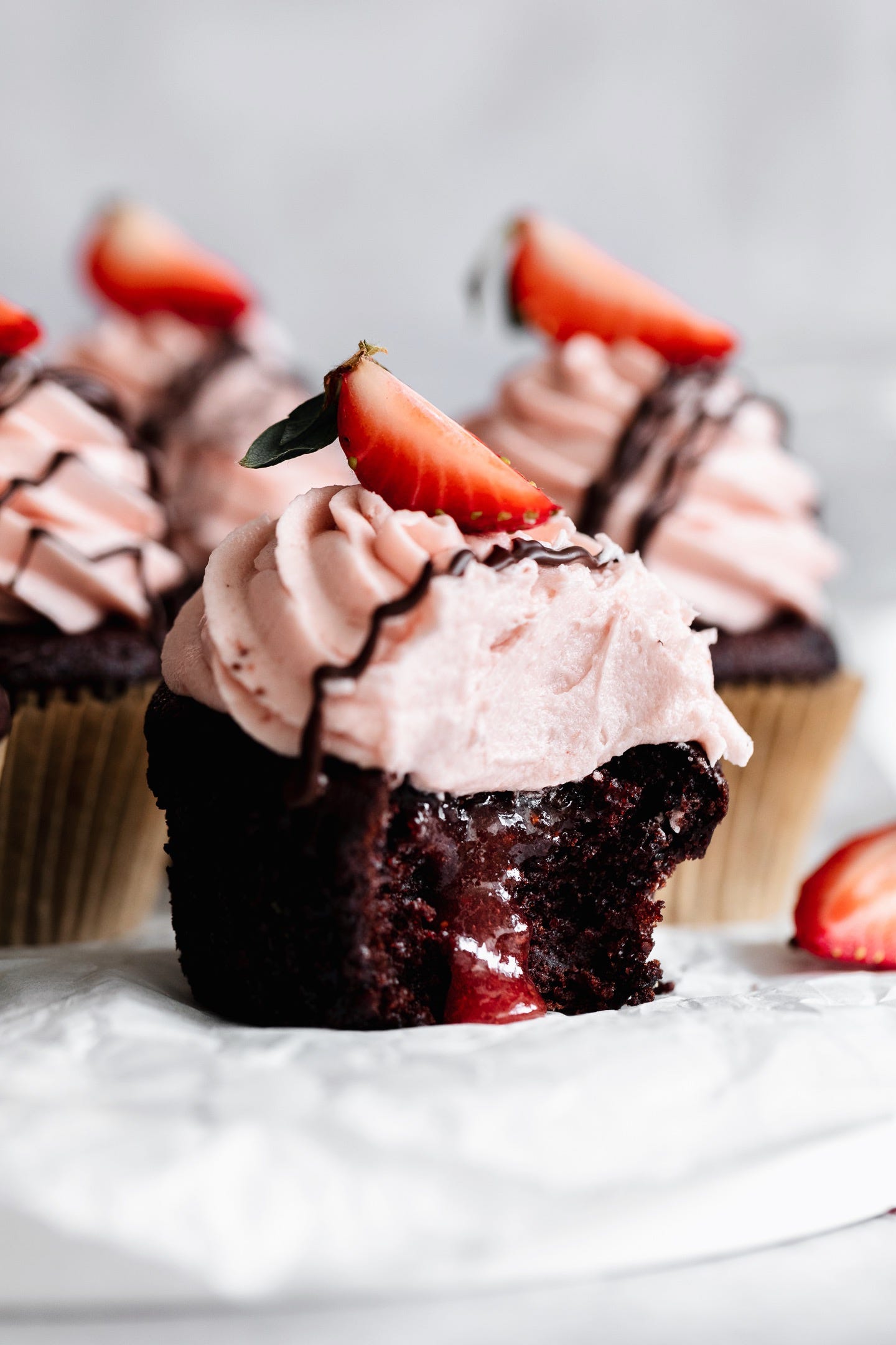 Close up shot of vegan chocolate dipped strawberry cupcake