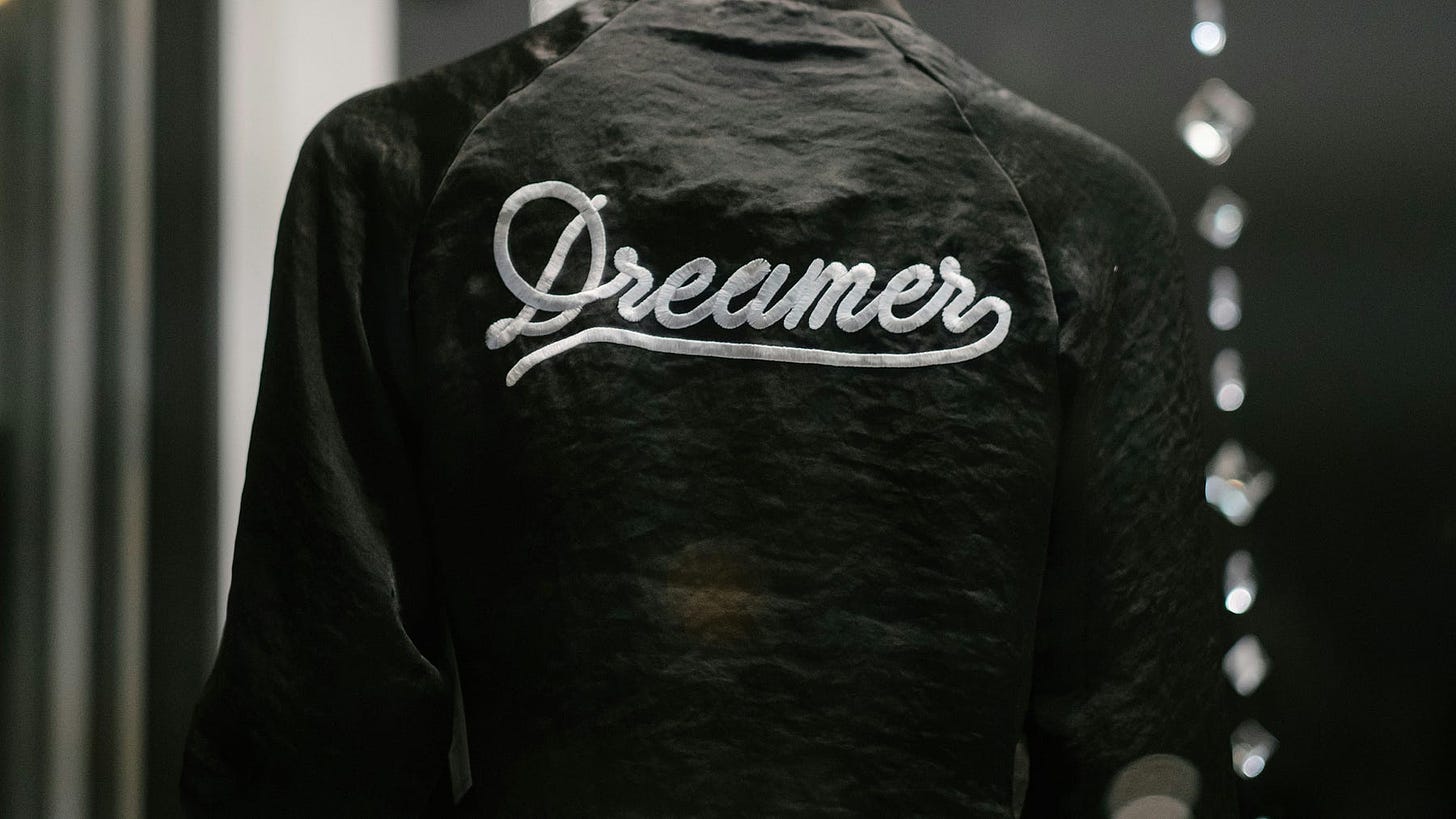 Black jacket with the word “Dreamer” inscribed on it.