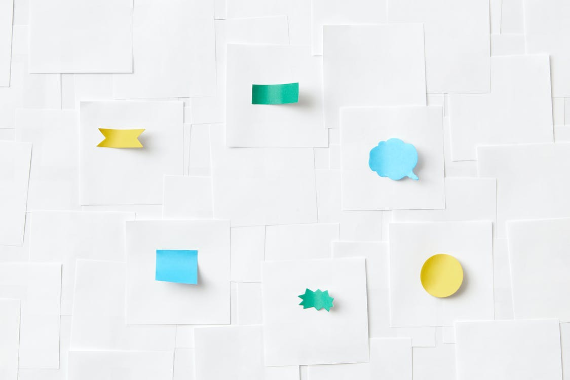 Free A Variety of Sticky Notes Stuck on White Papers Stock Photo