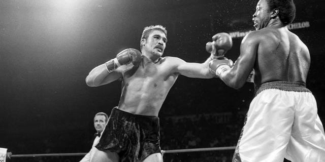 Gerrie Coetzee, left, lands a punch against Michael Dokes during the fight at Richfield Coliseum in Richfield, Ohio. Coetzee won by a KO in the 10th round. 