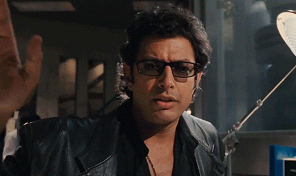 Ian Malcom of Jurassic Park, wearing all black and sunglasses, saying "Life, uh, finds a way."