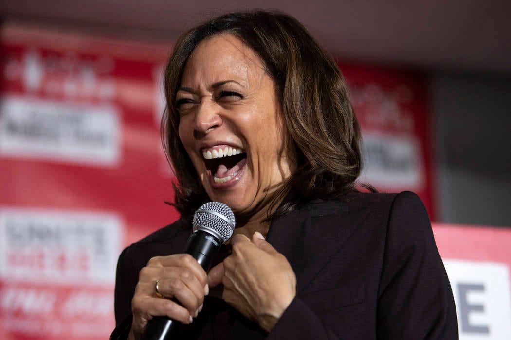 Presidential candidate Kamala Harris laughs while speaking to the crowd at a town hall hosted b