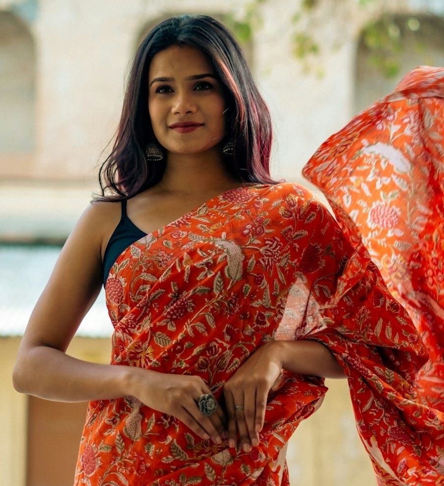 a woman in a red and white sari