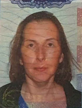 Woman with zoned-out expression, shoulder length brown hair. Looks like a mug shot, was my old passport photo.