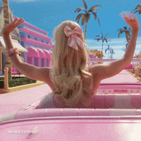 barbie in her pink car waving to everyone in barbieland
