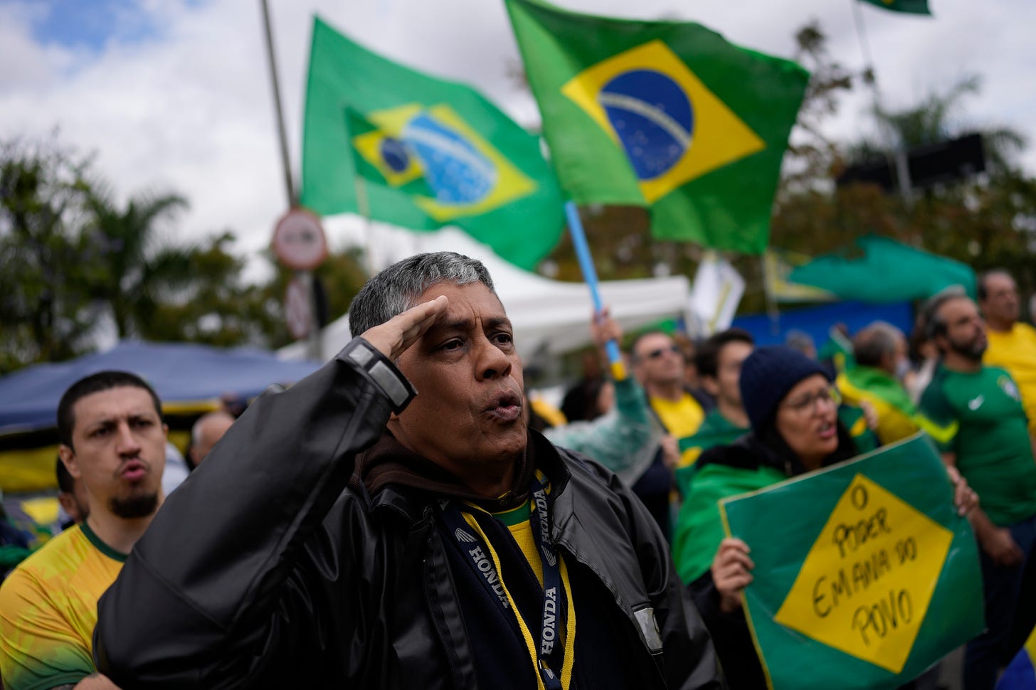 A supporter of Brazilian President Jair Bolsonaro salutes while singing the nation's anthem outside a military base during a protest against his reelection defeat in Sao Paulo, Brazil.