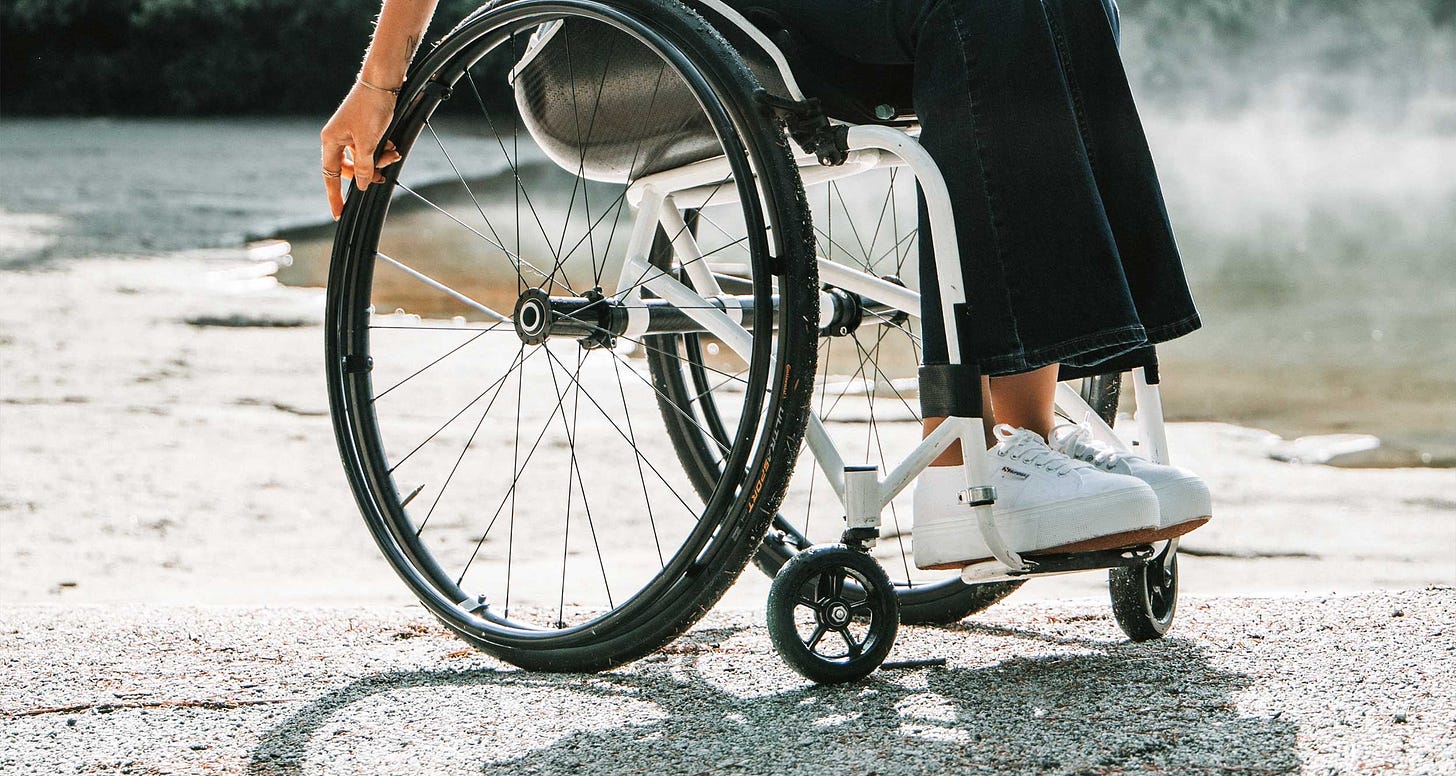Close-up of young woman in manual wheelchair.