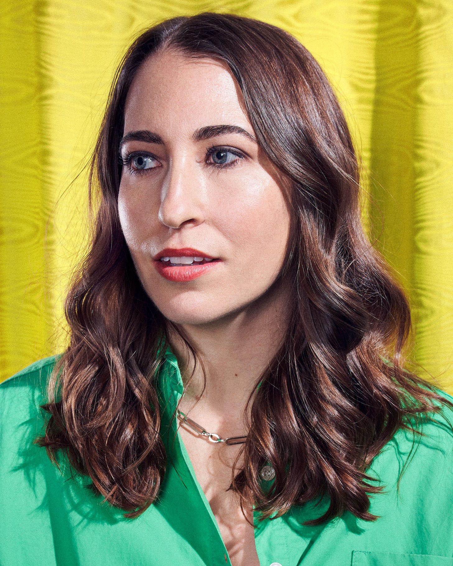 Photo of Rachel Karten wearing a green shirt and looking off in the distance