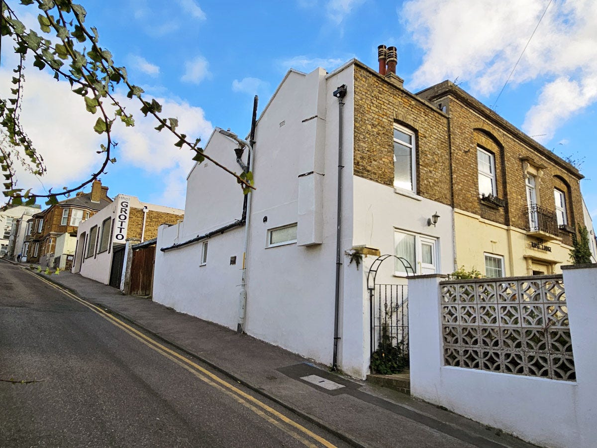 A series of buildings on an upwardly-sloping street