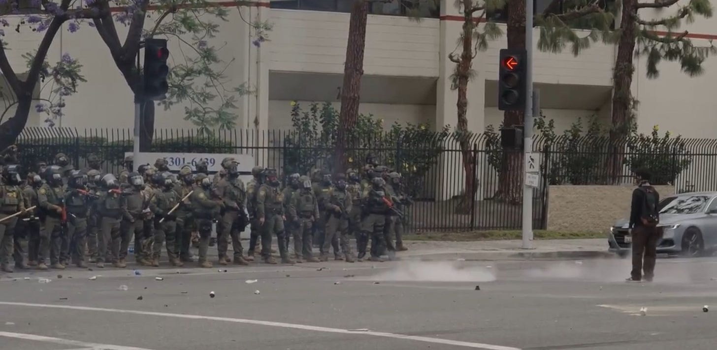 Lone skater faces armed soldiers 