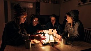 Family sitting by the candles during the blackout.