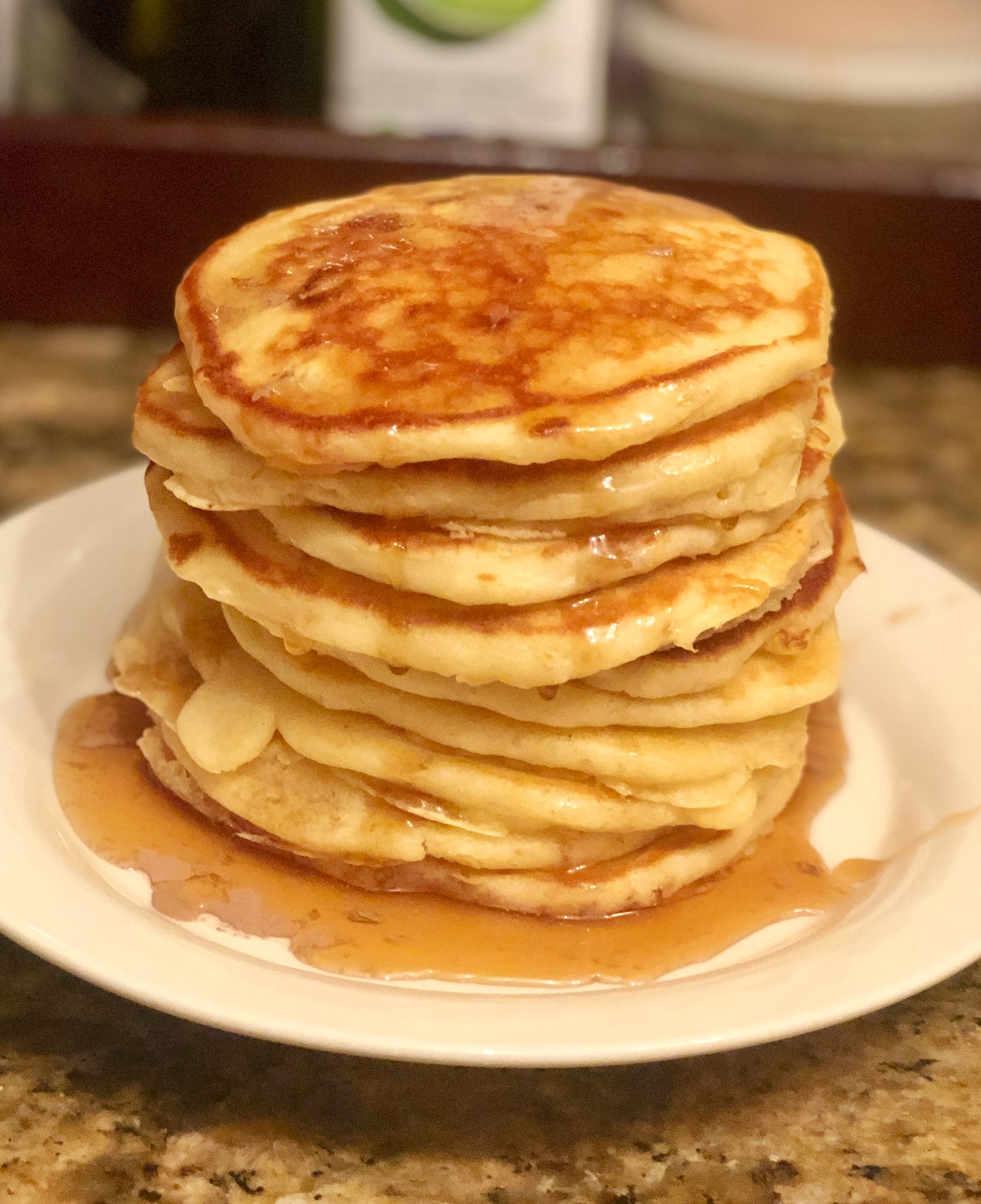 A stack of pancakes with syrup on a plate