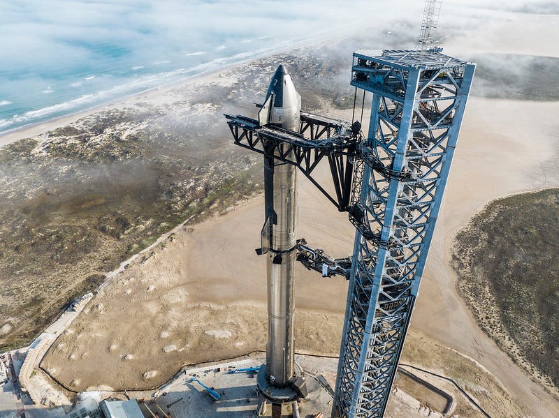 Starship stacked ontop of booster next to launch tower. Official SpaceX photo.