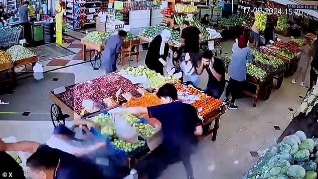 This is the moment a pager exploded in a supermarket, blowing its owner (bottom left) to the ground and causing significant injuries