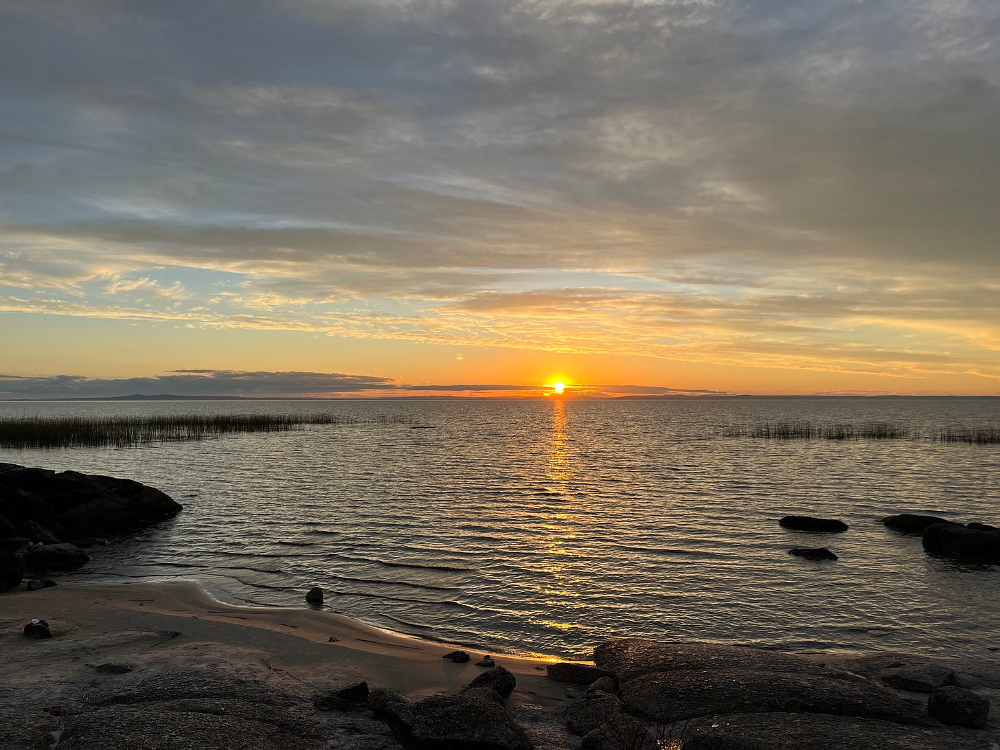 a sunset reflecting off the water of laguna negra at sunset on a cloudy day