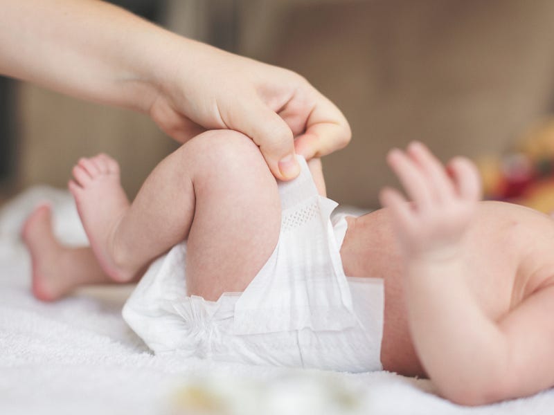 Photo by danchooalex on Getty Images - it's a man's hand changing a baby's nappy.