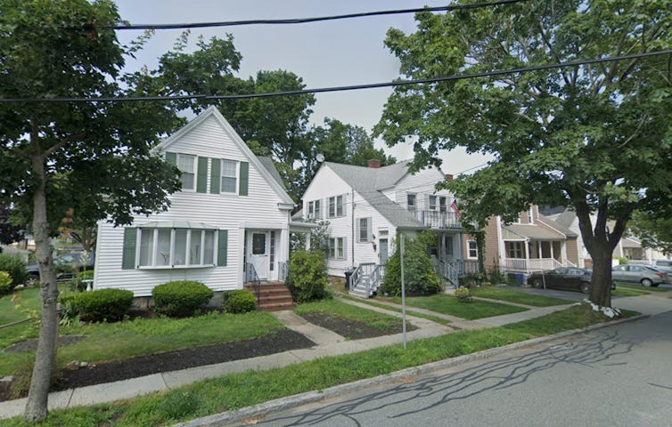 Three homes side by side on a leafy suburban street. Three homes side by side on a leafy suburban street.
