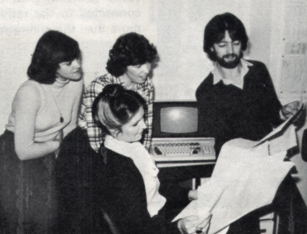 Me at 24, showing Jane Bush, Cathy Wiggins and Lorna Ely a pile of paper. Behind us sits the computer, all 10 megabytes of it.