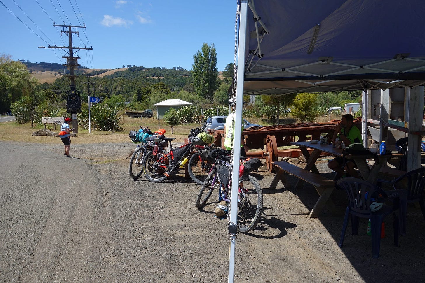 A group of bikepackers at Donnelly’s crossing, a rest stop on a gravel road.