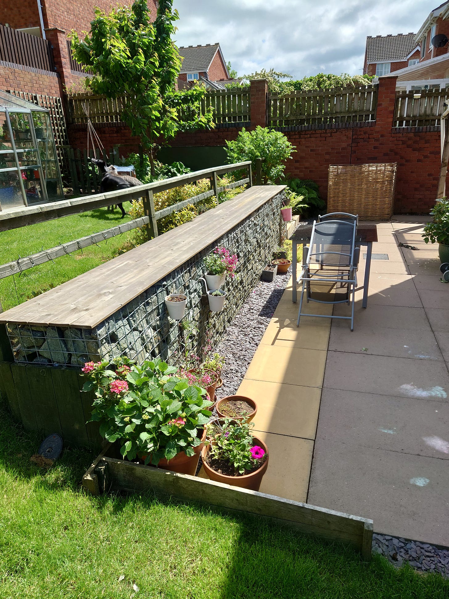 Photo of gabion wall, patio and some of upper back garden