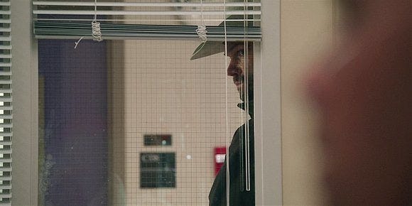 Walker Cordell creeping around James hospital door entrance with gun.