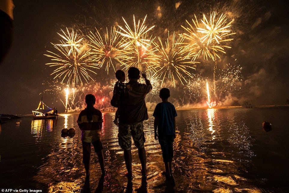 JAKARTA: Local residents look at fireworks as they celebrate the New Year at Ancol Beach in Jakarta on January 1, 2025