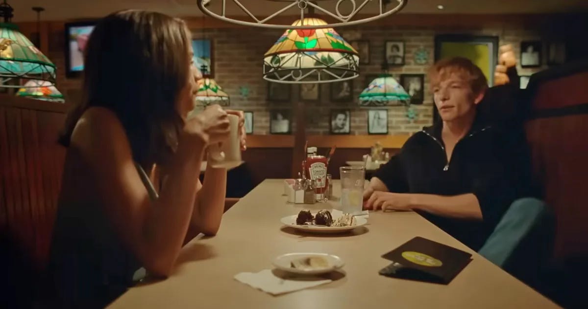 Applebees scene from Challengers - Zendaya and Mike Faist lust over each other across the table at Applebees