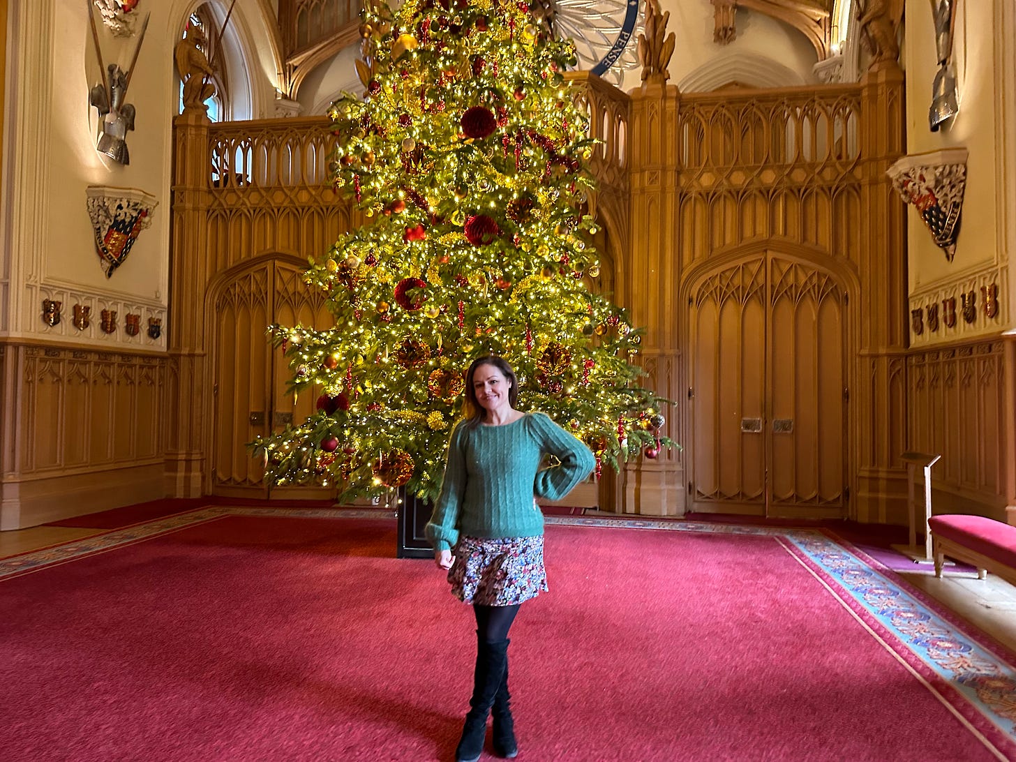 Emily Nash standing in front huge decorated Christmas tree