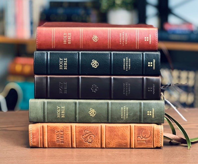 a stack of books sitting on top of a wooden table a stack of books sitting on top of a wooden table