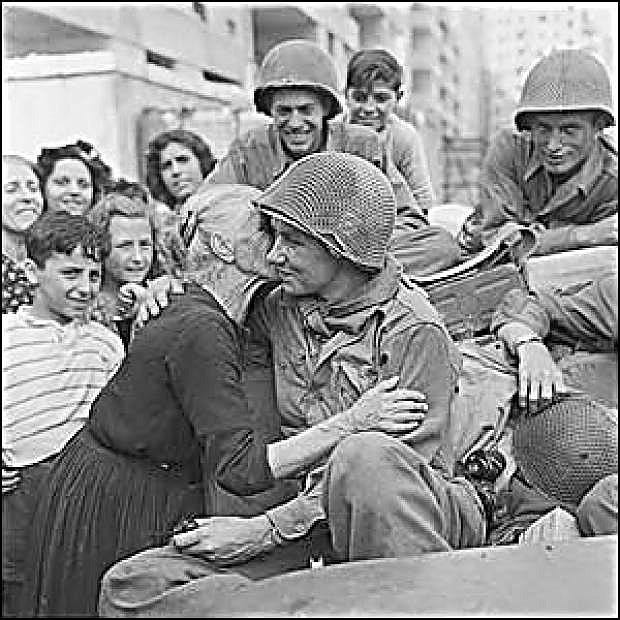 An Italian woman kisses an American G.I. after the liberation of Rome during World War II.