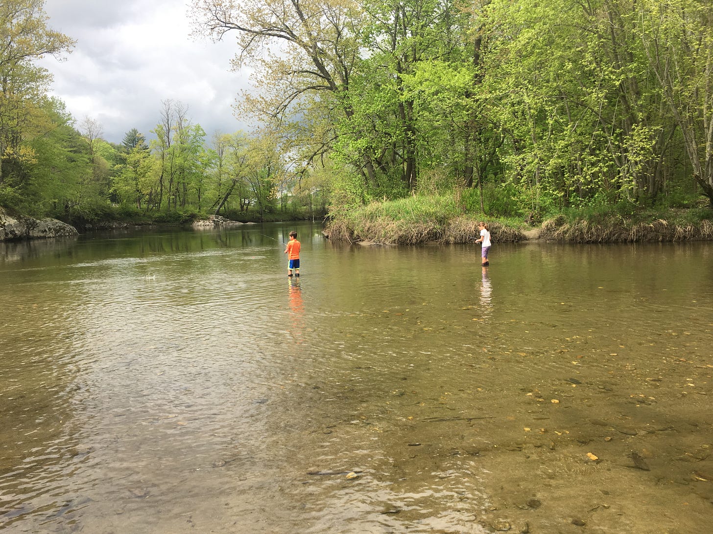 Two kids fishing on the Lamoille River in Vermont.