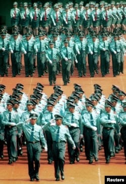 FILE - Chinese private secuity guards take part in a 7,000-strong annual parade in the southern city of Shenzhen, Aug. 20, 2001. Private security companies are growing significantly in China.