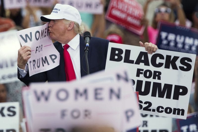 donald trump kissing women for trump sign