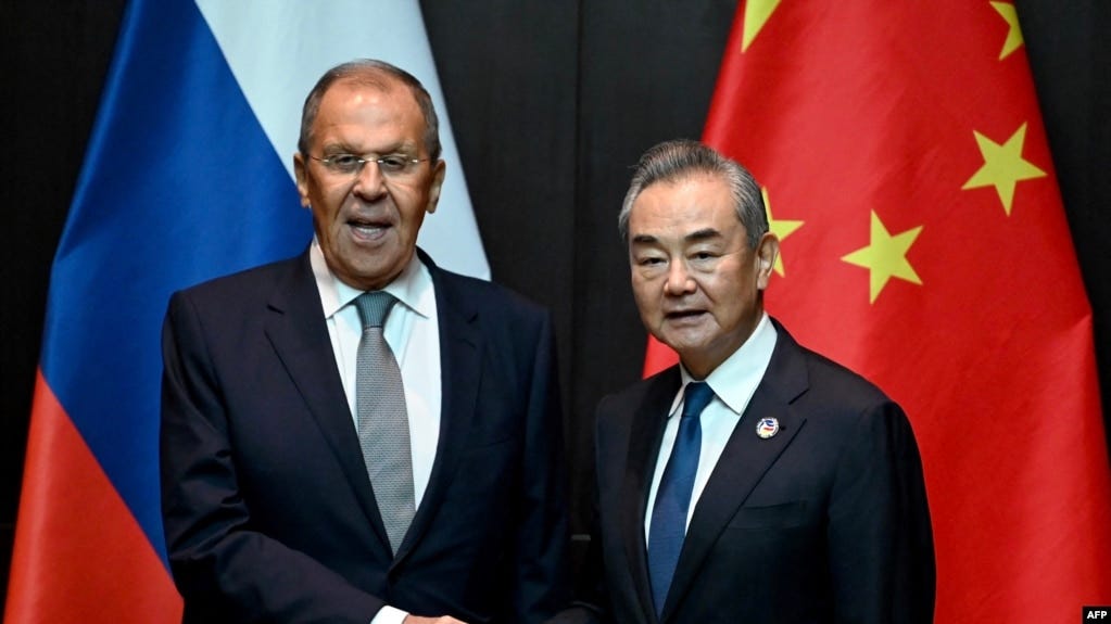 China's Foreign Minister Wang Yi, right, shakes hands with Russia's Foreign Minister Sergei Lavrov during a ministerial meeting on the sidelines of the Association of Southeast Asian Nations foreign ministers' meeting in Vientiane, Laos, on July 25, 2024.