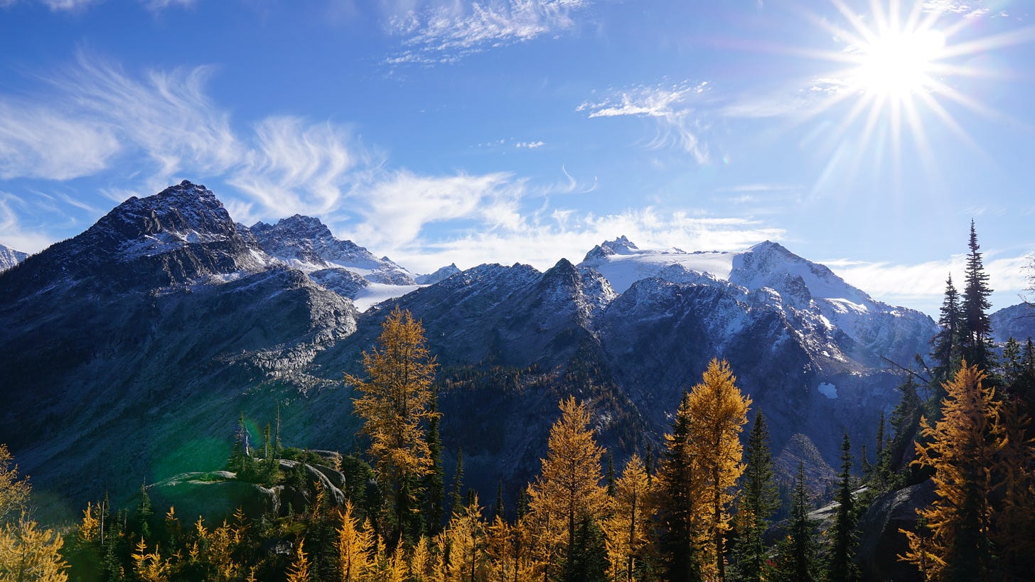 Mountain range, blue sky and colorful larches