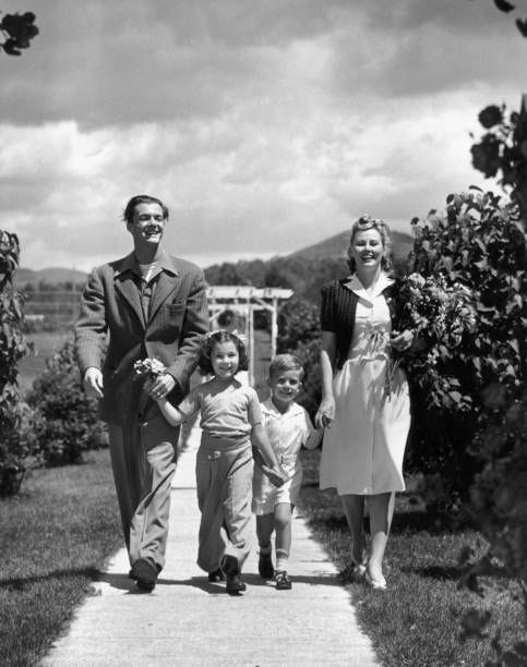 family walking through park - 1950s boy walking away stock pictures, royalty-free photos & images