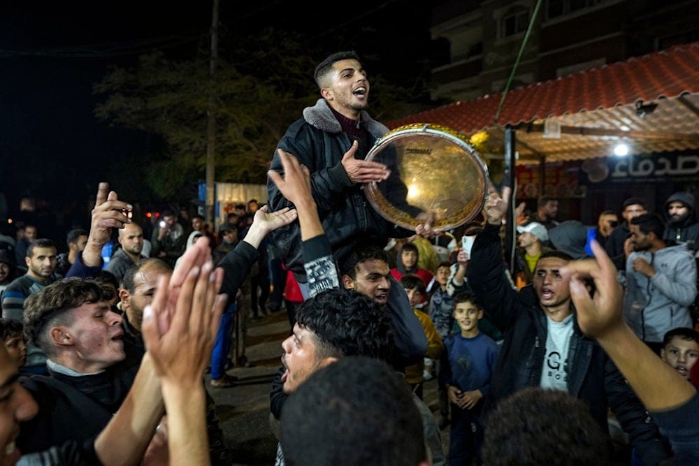 Palestinians celebrate the announcement of the Gaza ceasefire in Deir al-Balah, central Gaza Strip, Wednesday, January 15, 2025 (AP)