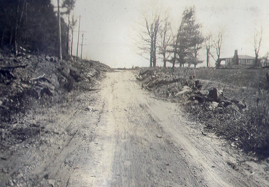 Road with lodge on right